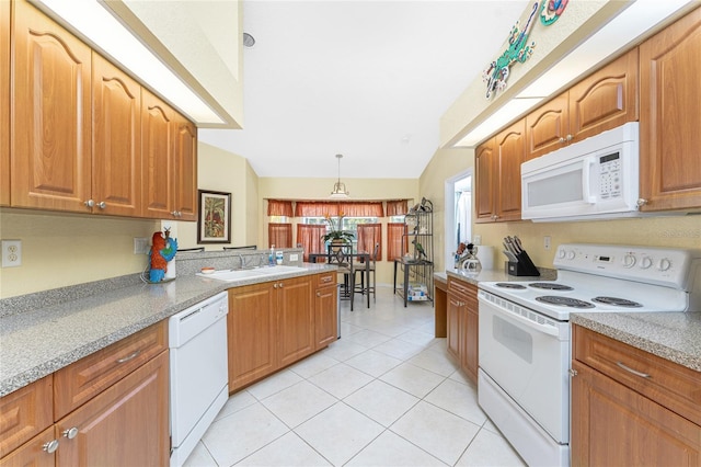 kitchen with decorative light fixtures, light tile patterned floors, brown cabinets, white appliances, and a sink