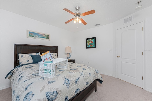 bedroom featuring visible vents, baseboards, ceiling fan, and carpet floors