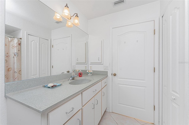 bathroom featuring tile patterned floors, visible vents, a chandelier, and vanity