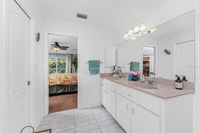 ensuite bathroom featuring a sink, visible vents, connected bathroom, and double vanity