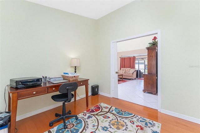 office space featuring baseboards and wood finished floors