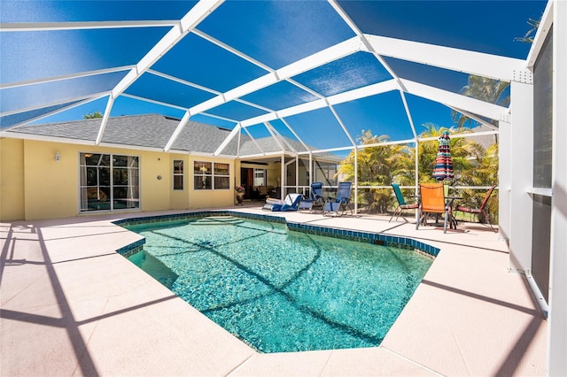 pool featuring a patio area and glass enclosure