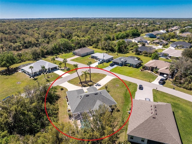 birds eye view of property with a residential view and a forest view