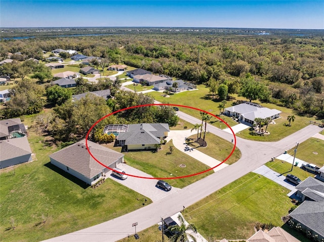 bird's eye view featuring a forest view and a residential view