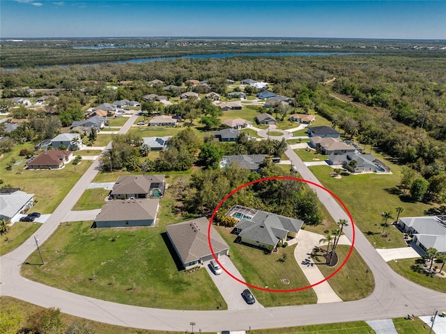 aerial view featuring a residential view, a view of trees, and a water view