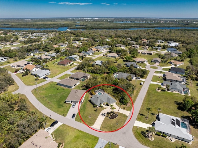 bird's eye view featuring a view of trees, a water view, and a residential view