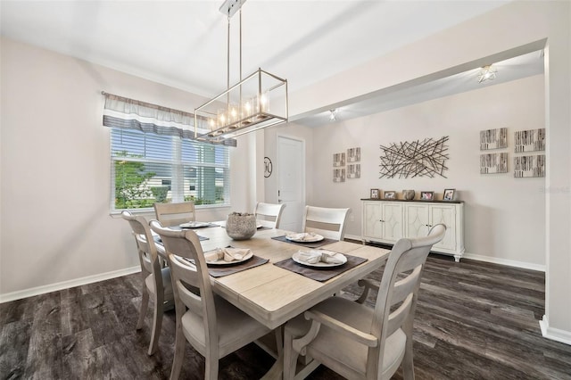 dining space featuring baseboards and dark wood finished floors