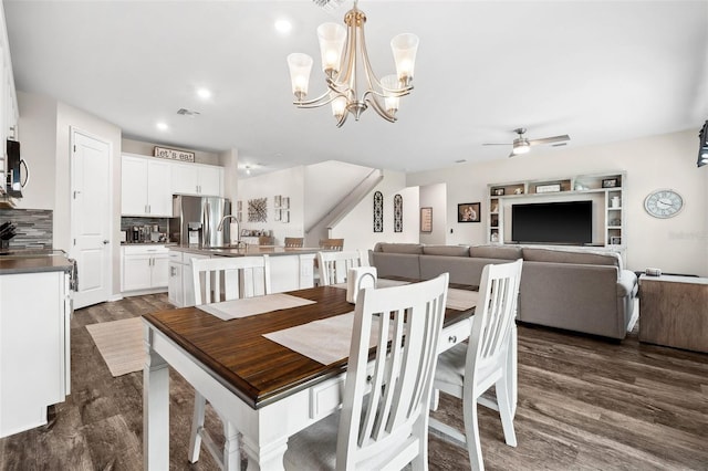 dining space featuring visible vents, recessed lighting, ceiling fan with notable chandelier, and dark wood-style flooring