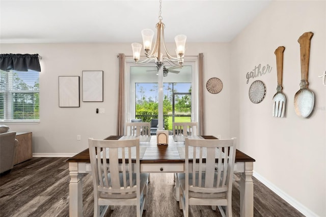 dining area featuring a chandelier, baseboards, and wood finished floors