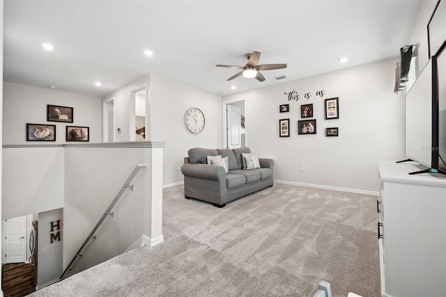 living area with recessed lighting, baseboards, light colored carpet, and a ceiling fan