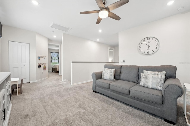 living room with baseboards, ceiling fan, light colored carpet, attic access, and recessed lighting