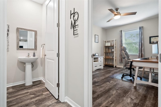 home office featuring a ceiling fan, dark wood-style floors, and baseboards