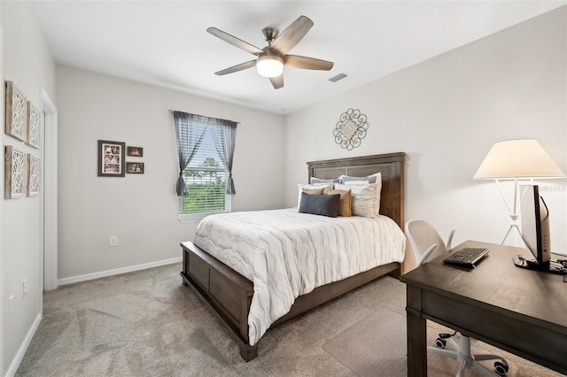 bedroom with visible vents, light carpet, baseboards, and ceiling fan