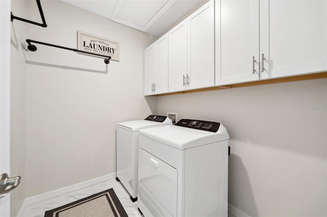 laundry room with washer and clothes dryer, marble finish floor, cabinet space, and baseboards