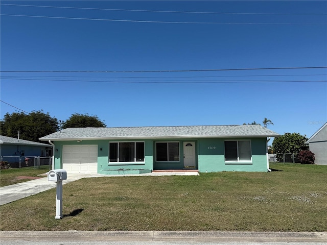 view of front of house featuring driveway, an attached garage, a front lawn, and fence