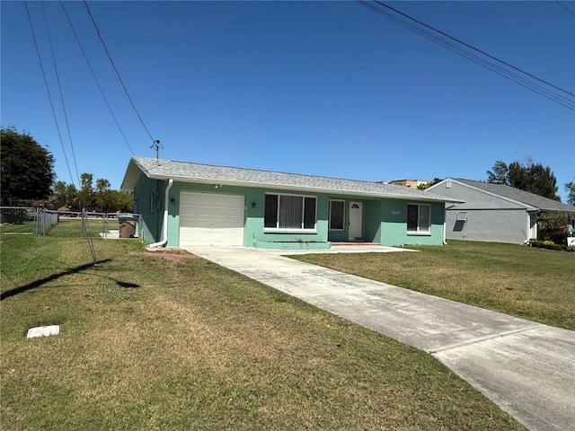 ranch-style house featuring a front yard, fence, driveway, stucco siding, and a garage