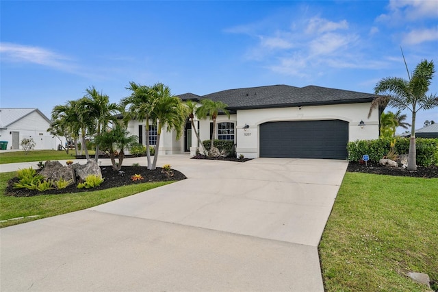 view of front facade featuring stucco siding, driveway, a front yard, and an attached garage