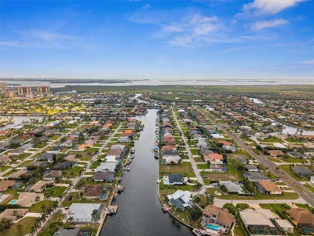 birds eye view of property featuring a water view and a residential view