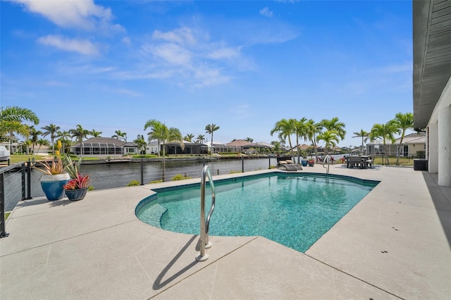 pool featuring a patio, fence, a water view, and a residential view