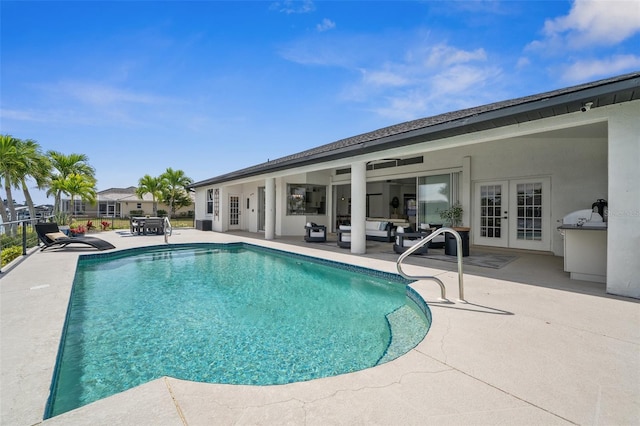 view of swimming pool featuring fence, a fenced in pool, french doors, outdoor lounge area, and a patio area