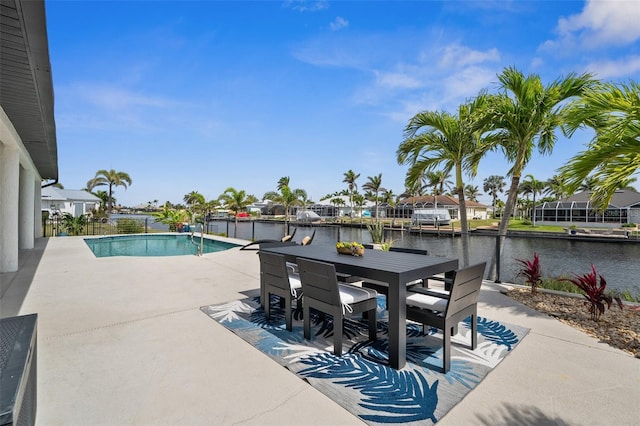 outdoor pool featuring a patio area, outdoor dining space, and a water view