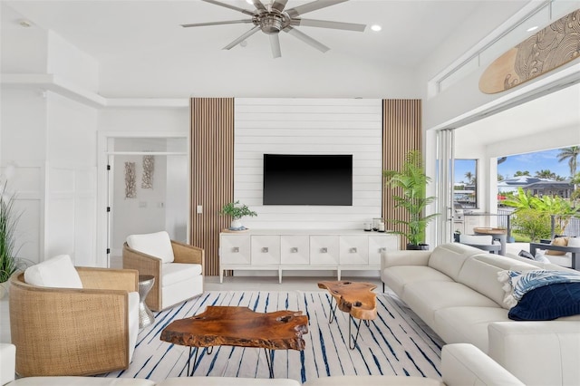 living area with lofted ceiling and ceiling fan