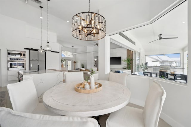 dining space with recessed lighting and ceiling fan with notable chandelier