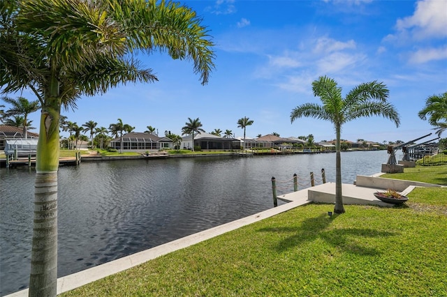 view of dock featuring a residential view, a yard, and a water view