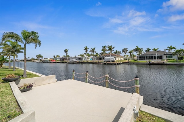 view of dock with a residential view and a water view