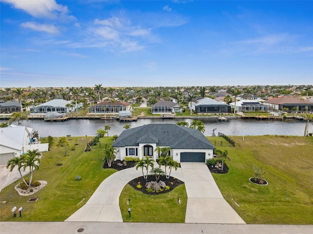 birds eye view of property with a residential view and a water view