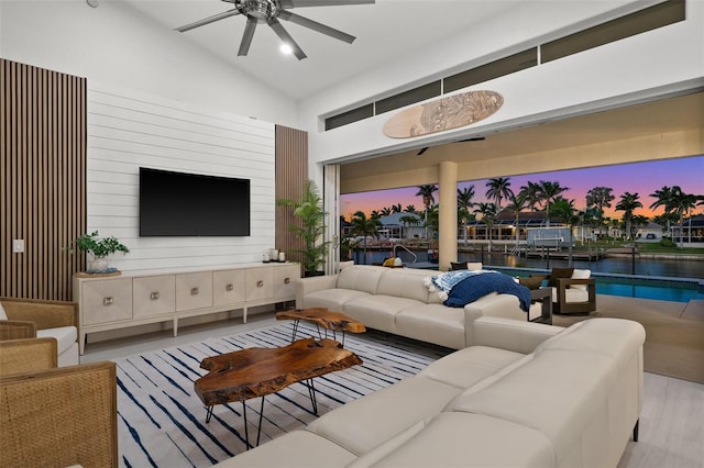 living room featuring wood finished floors, lofted ceiling, and ceiling fan