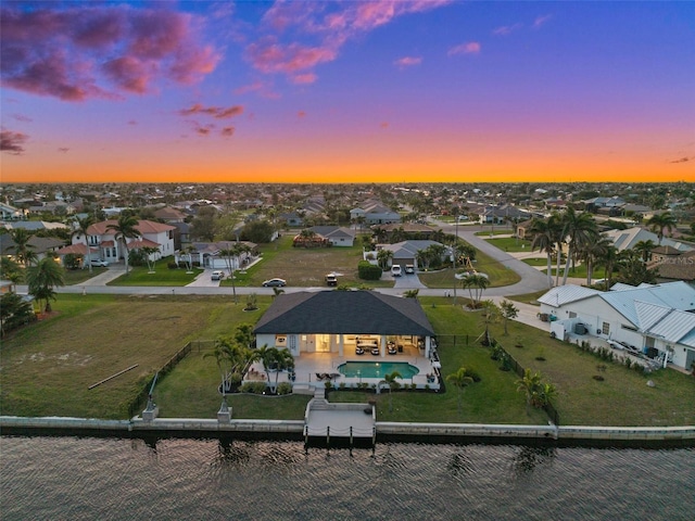 bird's eye view with a residential view and a water view