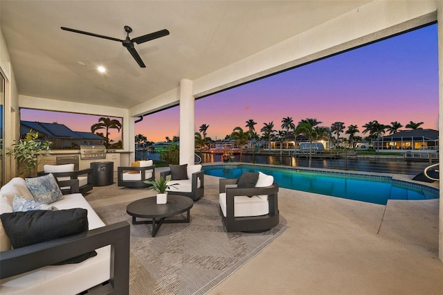 pool at dusk featuring a grill, outdoor lounge area, a patio, and a ceiling fan