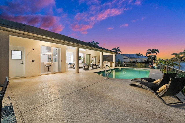 pool at dusk featuring a fenced in pool, a patio, and fence