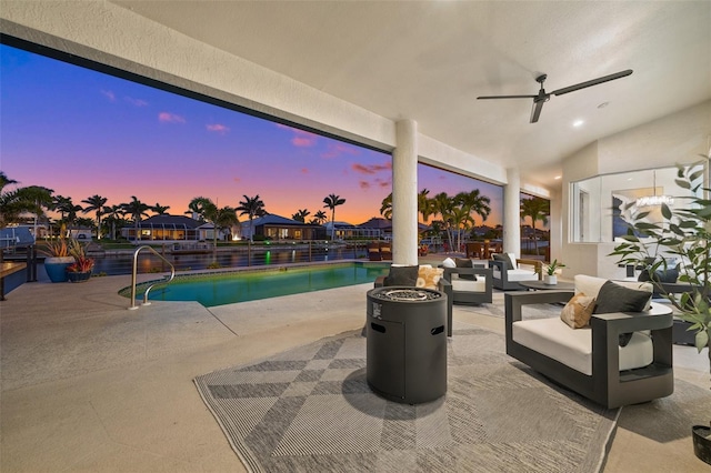 view of patio with a fenced in pool and ceiling fan