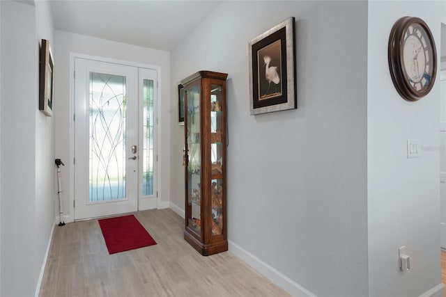 foyer entrance featuring wood finished floors and baseboards