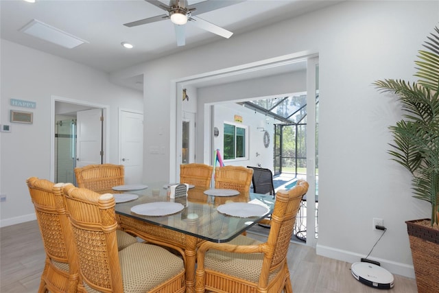 dining room with recessed lighting, light wood-style flooring, baseboards, and a sunroom