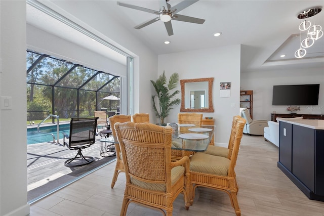 dining area with light wood finished floors, recessed lighting, baseboards, and a sunroom