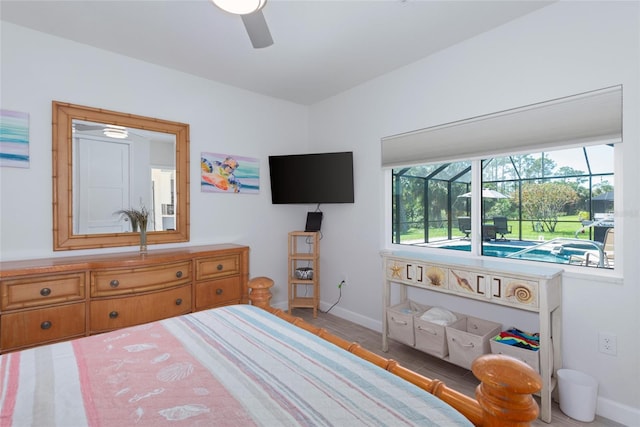 bedroom featuring a ceiling fan, baseboards, and a sunroom