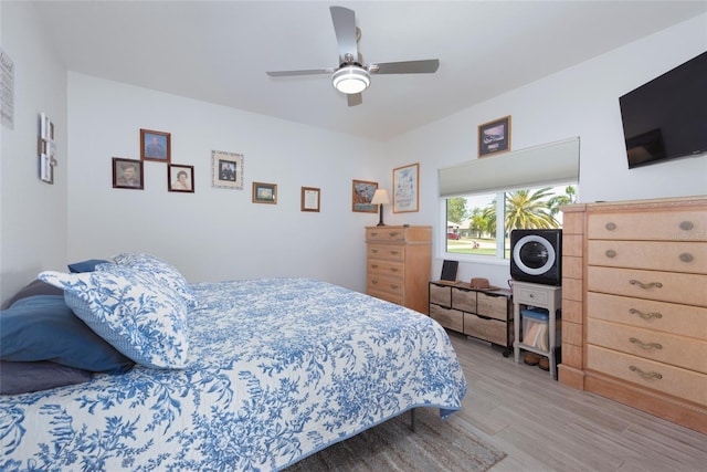 bedroom with light wood finished floors and ceiling fan