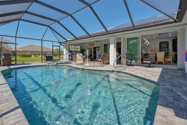 view of pool featuring a patio, a lanai, a ceiling fan, and a pool with connected hot tub