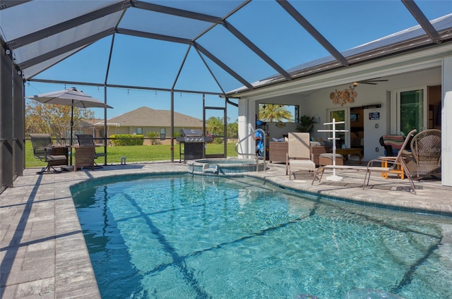 view of pool featuring a patio area, a lanai, a pool with connected hot tub, and a ceiling fan