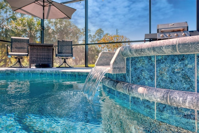 view of pool featuring grilling area