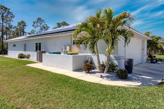 view of side of property with cooling unit, driveway, solar panels, a yard, and stucco siding