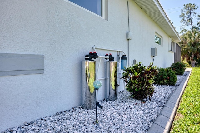 view of side of home with stucco siding