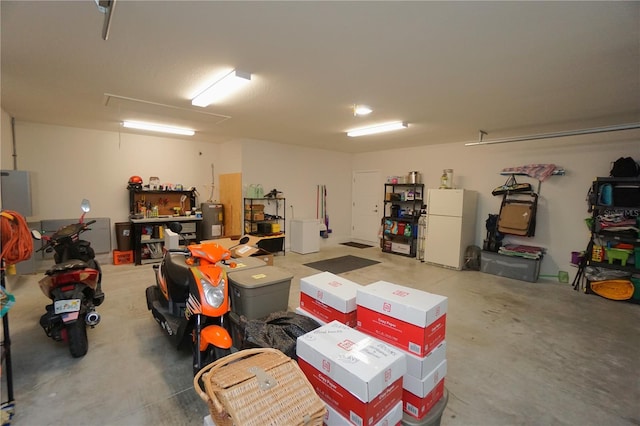 garage with freestanding refrigerator and electric water heater