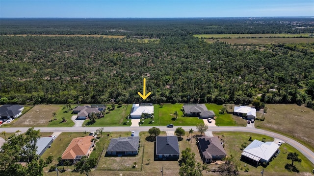 aerial view with a wooded view and a residential view