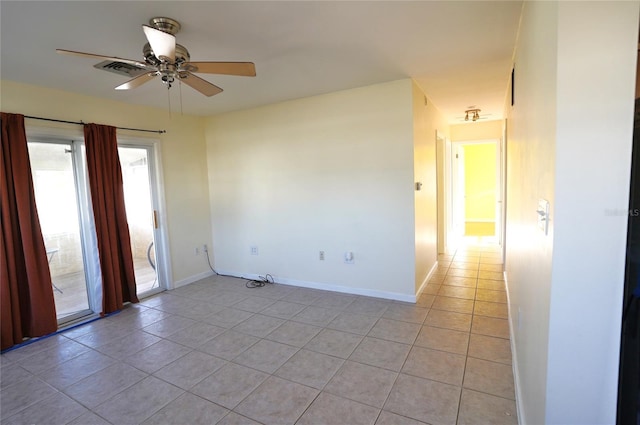 empty room featuring baseboards, light tile patterned flooring, and a ceiling fan