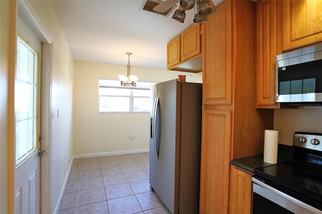 kitchen with baseboards, decorative light fixtures, ceiling fan with notable chandelier, light tile patterned flooring, and stainless steel appliances