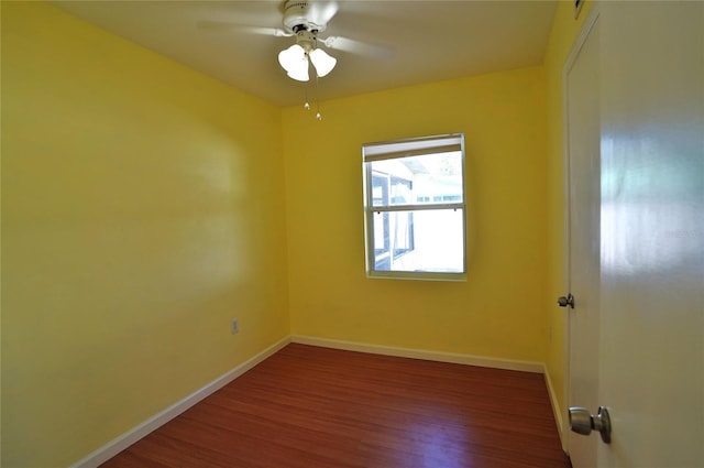 spare room with wood finished floors, baseboards, and ceiling fan